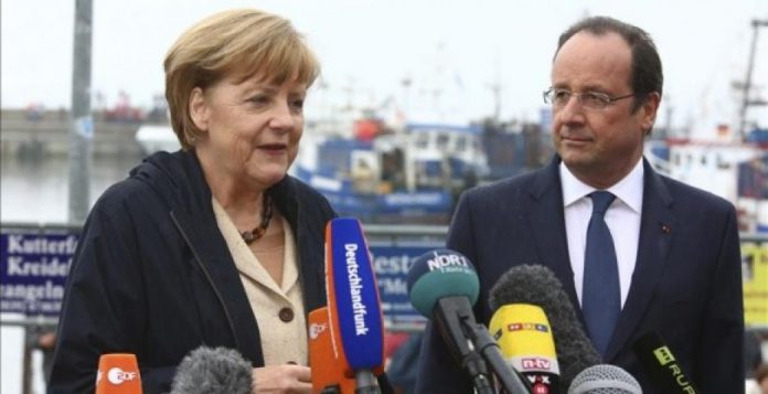 Merkel y Hollande durante un encuentro reciente